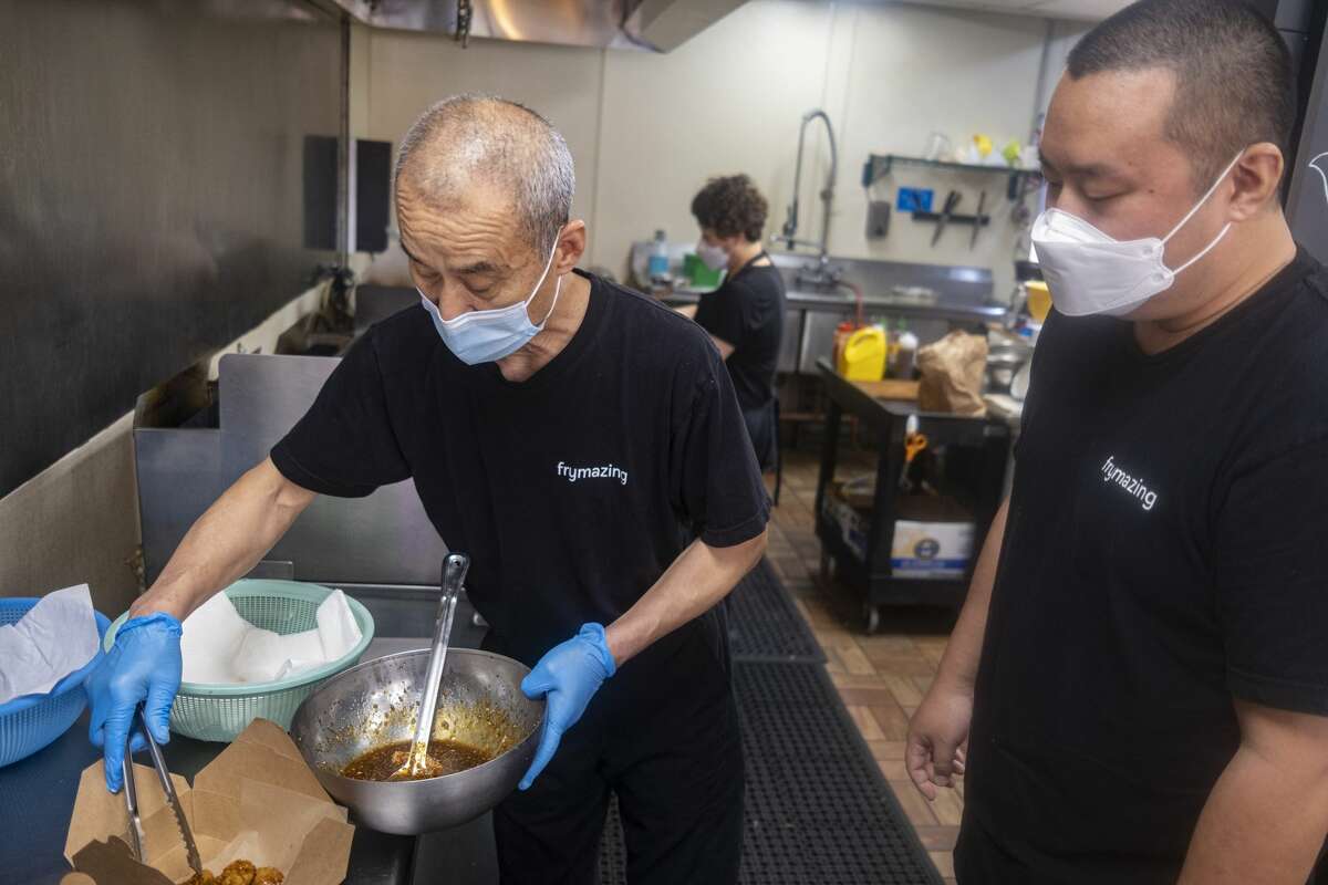 Yuh Il Yoon and son Tae Yoon make a chicken dish at Frymazing.