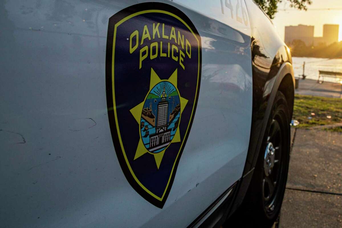 An Oakland police car. Oakland police said the death of a person found in a burned vehicle early Wednesday morning was being investigated as a homicide.