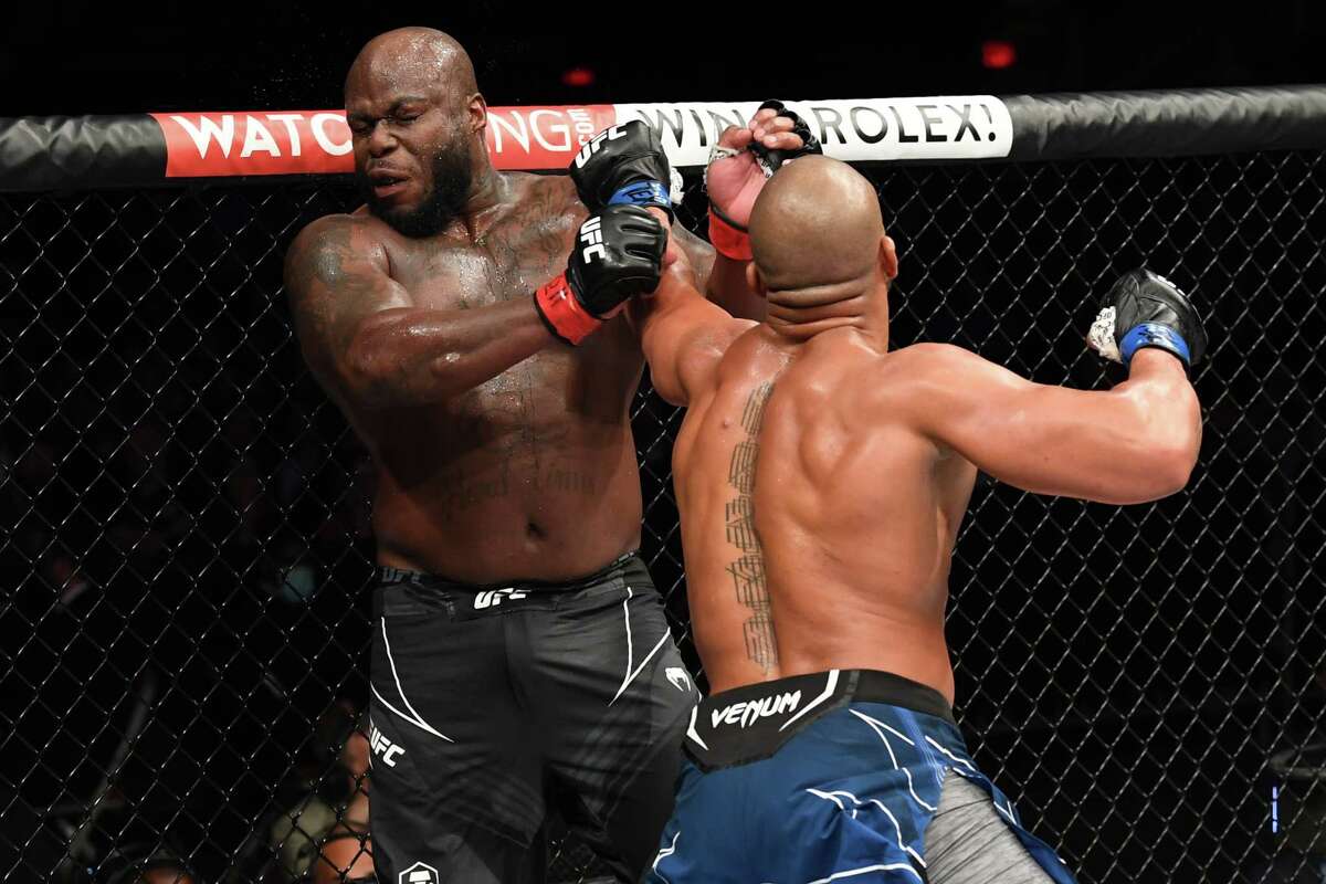 Ciryl Gane lands a big left hand that hurt Derrick Lewis late in the third round of their interim heavyweight title bout during the UFC 265 event at Toyota Center on August 07, 2021 in Houston, Texas.