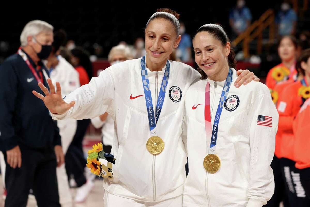 SAITAMA, JAPAN - AUGUST 08: Sue Bird #6 of Team United States and Diana Taurasi #12 pose for photographs with their gold medals during the Women's Basketball medal ceremony on day sixteen of the 2020 Tokyo Olympic games at Saitama Super Arena on August 08, 2021 in Saitama, Japan. (Photo by Kevin C. Cox/Getty Images)