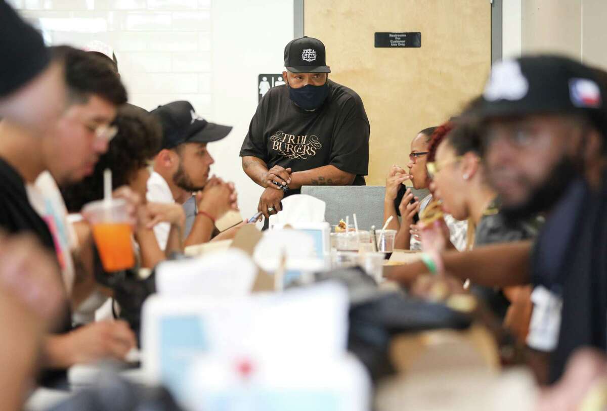 Bun B talks with patrons as they eat Sunday, Aug. 8, 2021, at Sticky’s Chicken in Houston. Bun B partnered with Andy Nguyen, Patsy Vivares and her brother Benson to open a new burger concept called Trill Burgers, which held an event at Sticky’s Chicken.