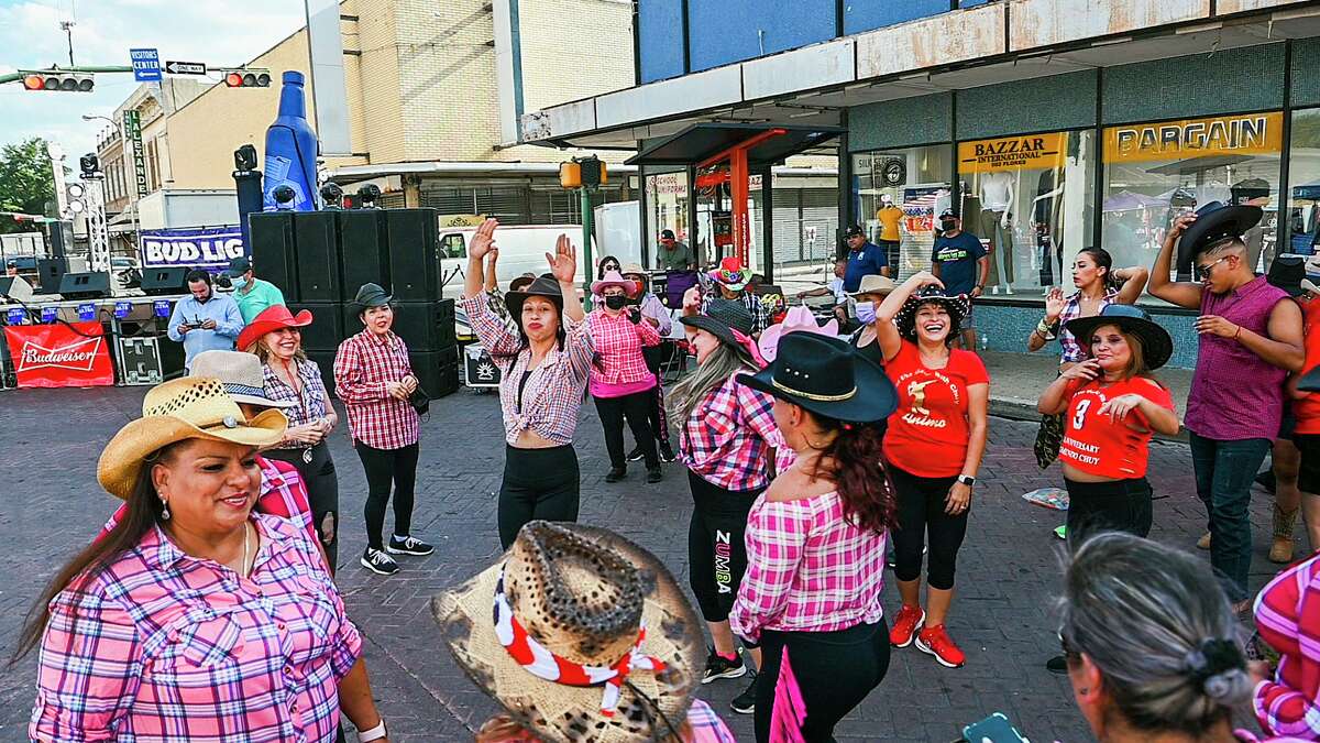 Zumba enthusiasts don cowboy hats as they dance Saturday, July 31, 2021 during Sombrero Fest in downtown Laredo.