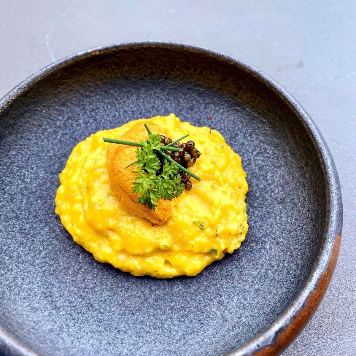 The "Eggs on Eggs on Eggs" (soft scrambled eggs topped with uni and Siberian osetra caviar) is a secret menu dish at 1751 Sea and Bar.
