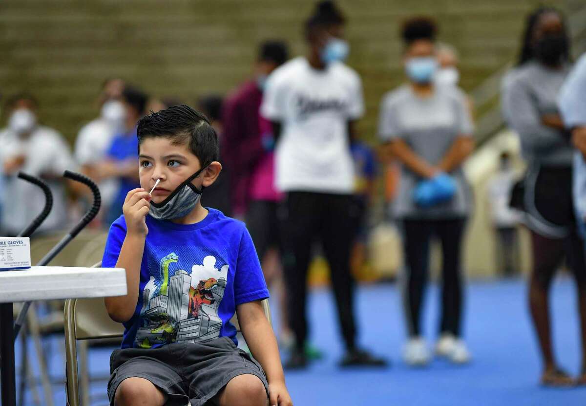 Aidan Rivera, a student at Bowden Academy in the San Antonio Independent School District, swabs his nose for a COVID-19 test at the Alamo Convocation Center in preparation for his first day of school.