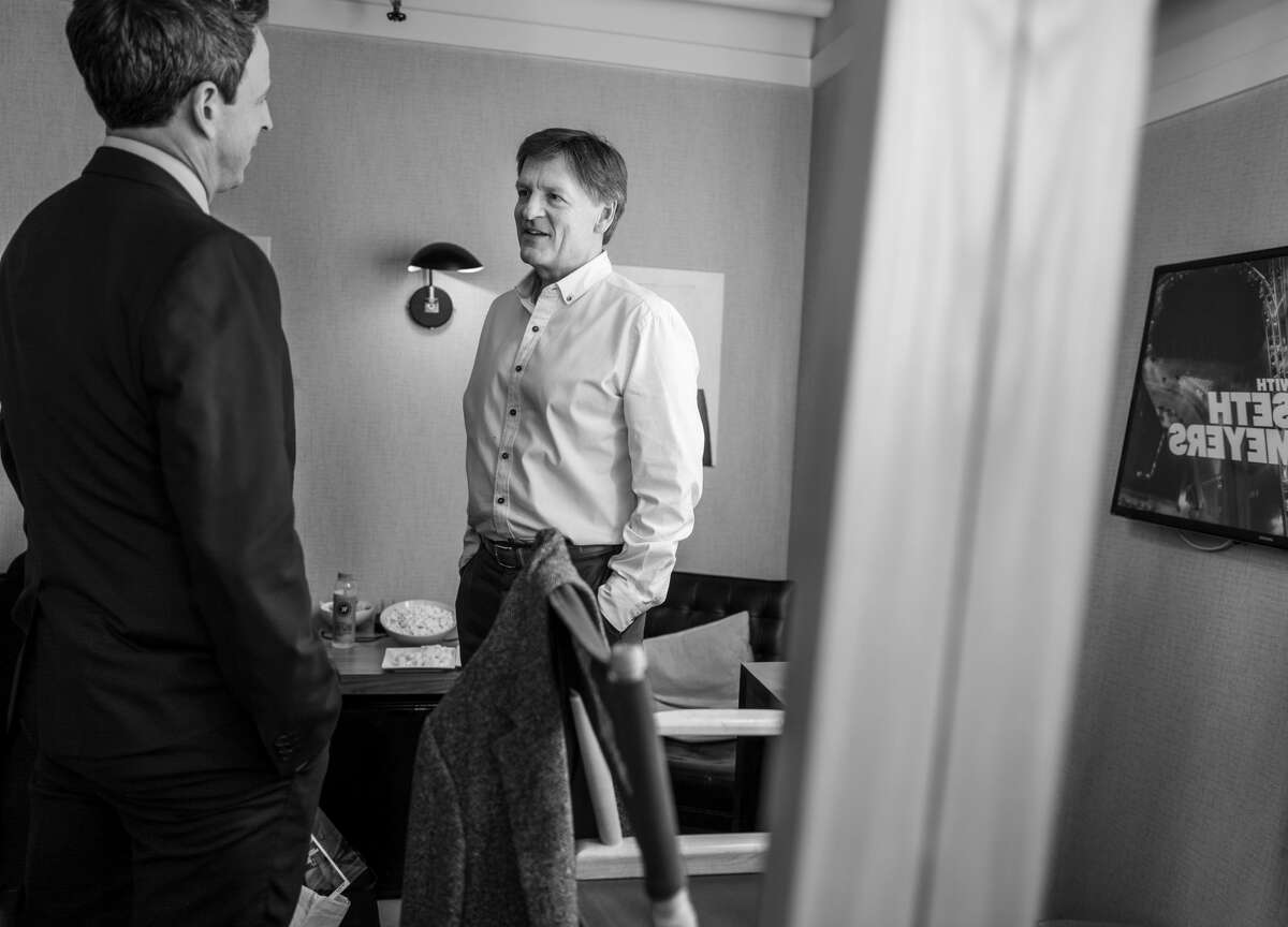 Seth Meyers talks with author Michael Lewis in 2019.