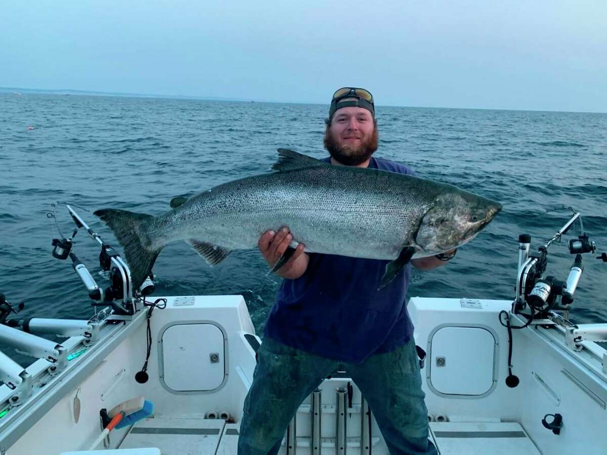 Joshua Jacobs, of Manistee, poses with a 37.22-pound salmon caught in Lake Michigan on Wednesday evening. (Courtesy photo)