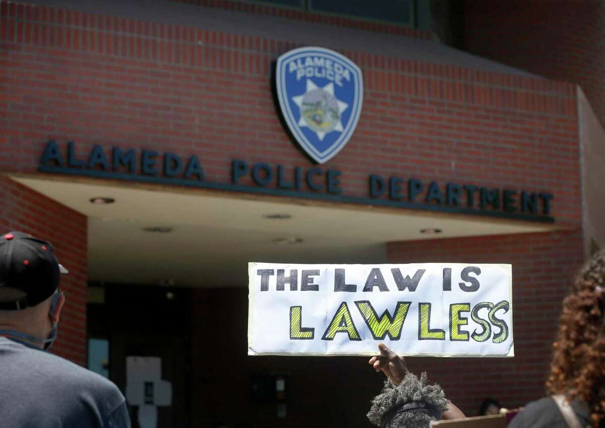 Demonstrators stage a sit-in at the Alameda Police Department to call attention to police brutality against people of color in Alameda, Calif. on Thursday, June 11, 2020.