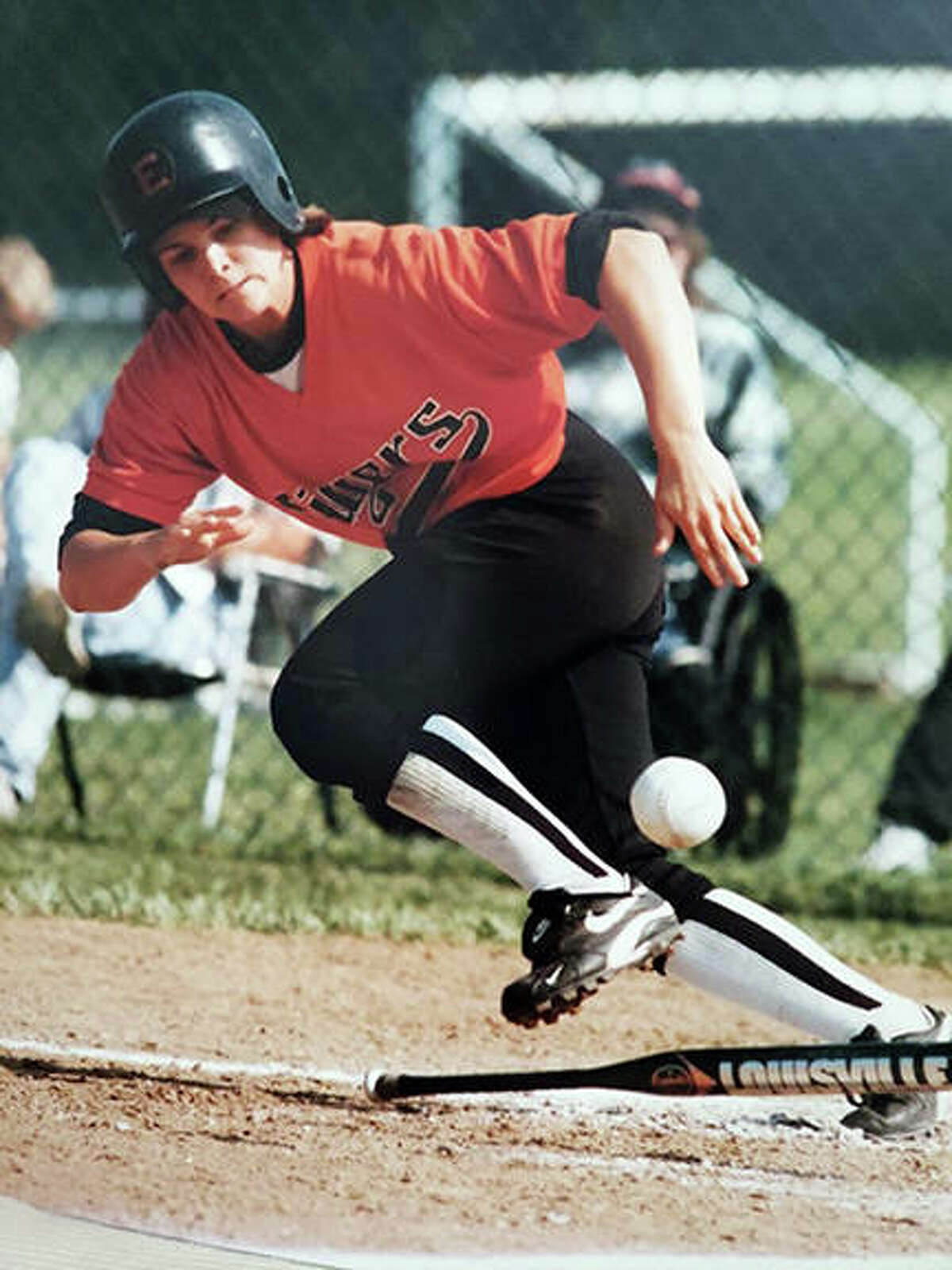 Jacque Woosley, a 1998 Edwardsville graduate, lays down a bunt during her softball playing days at EHS.