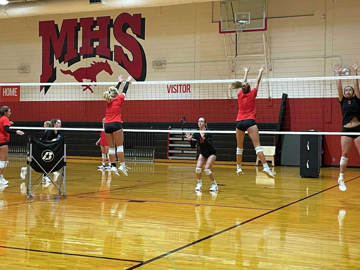 The Memorial volleyball team works on a blocking drill during practice on Aug. 5.