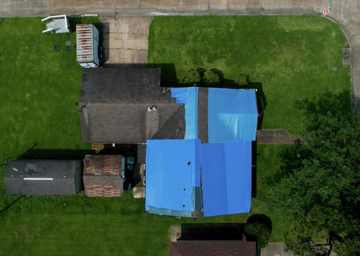 A plastic tarp covers the majority of a home's roof on Tuesday, June 15, 2021, in Port Arthur. The city did not receive any of the $1 billion in federal Hurricane Harvey money that the state of Texas distributed to local governments in May. The bulk of the funds went to counties that sustained the least damage from the storm. Aransas, Nueces and Jefferson counties, which sustained severe damage from Hurricane Harvey, collectively received $0.