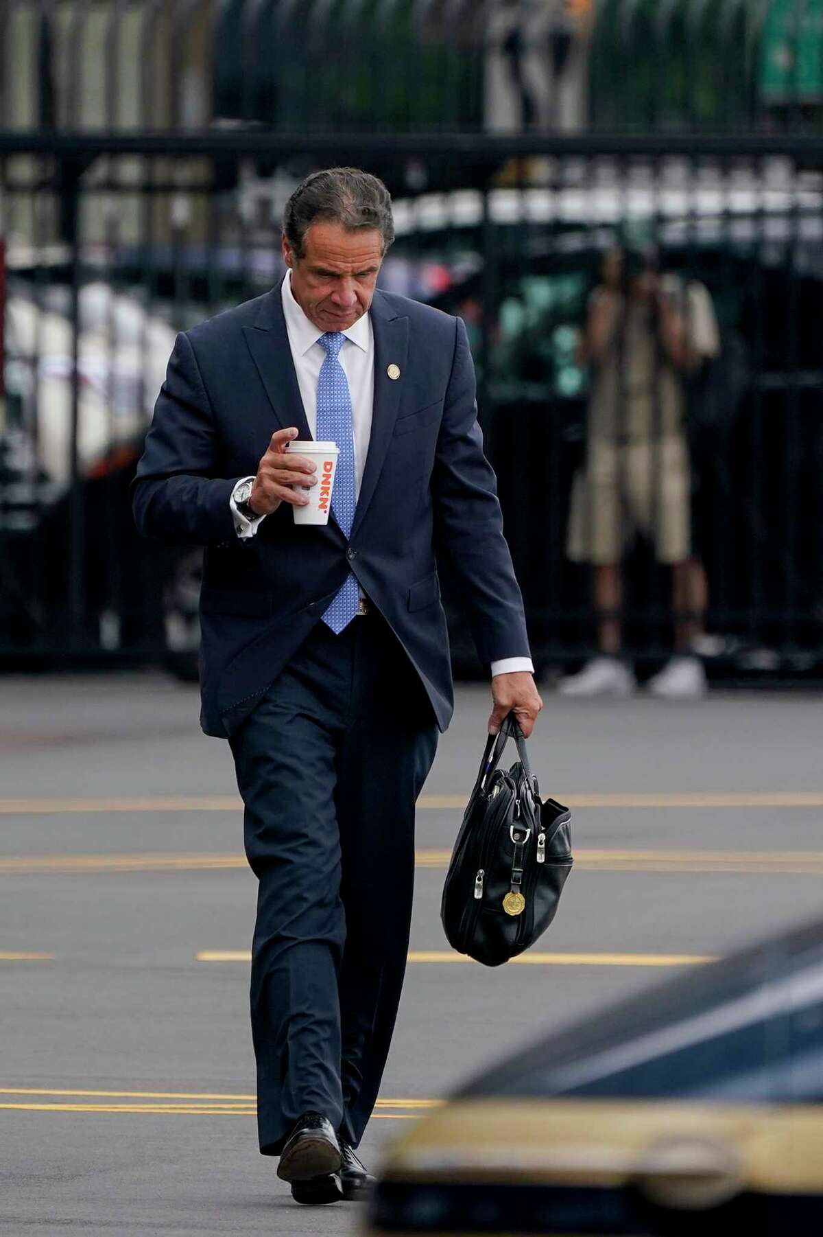 New York Gov. Andrew Cuomo prepares to board a helicopter after announcing his resignation, Tuesday, Aug. 10, 2021, in New York. Cuomo says he will resign over a barrage of sexual harassment allegations. The three-term Democratic governor's decision, which will take effect in two weeks, was announced Tuesday as momentum built in the Legislature to remove him by impeachment.