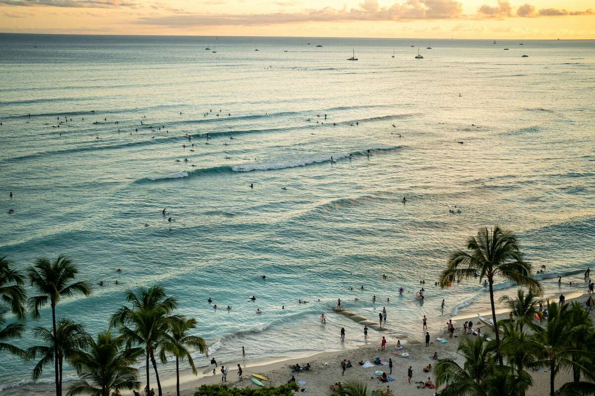 The sun sets off of Waikiki Beach on the Hawaiian island of Oahu on Saturday, June 26, 2021 in Honolulu, HI. 