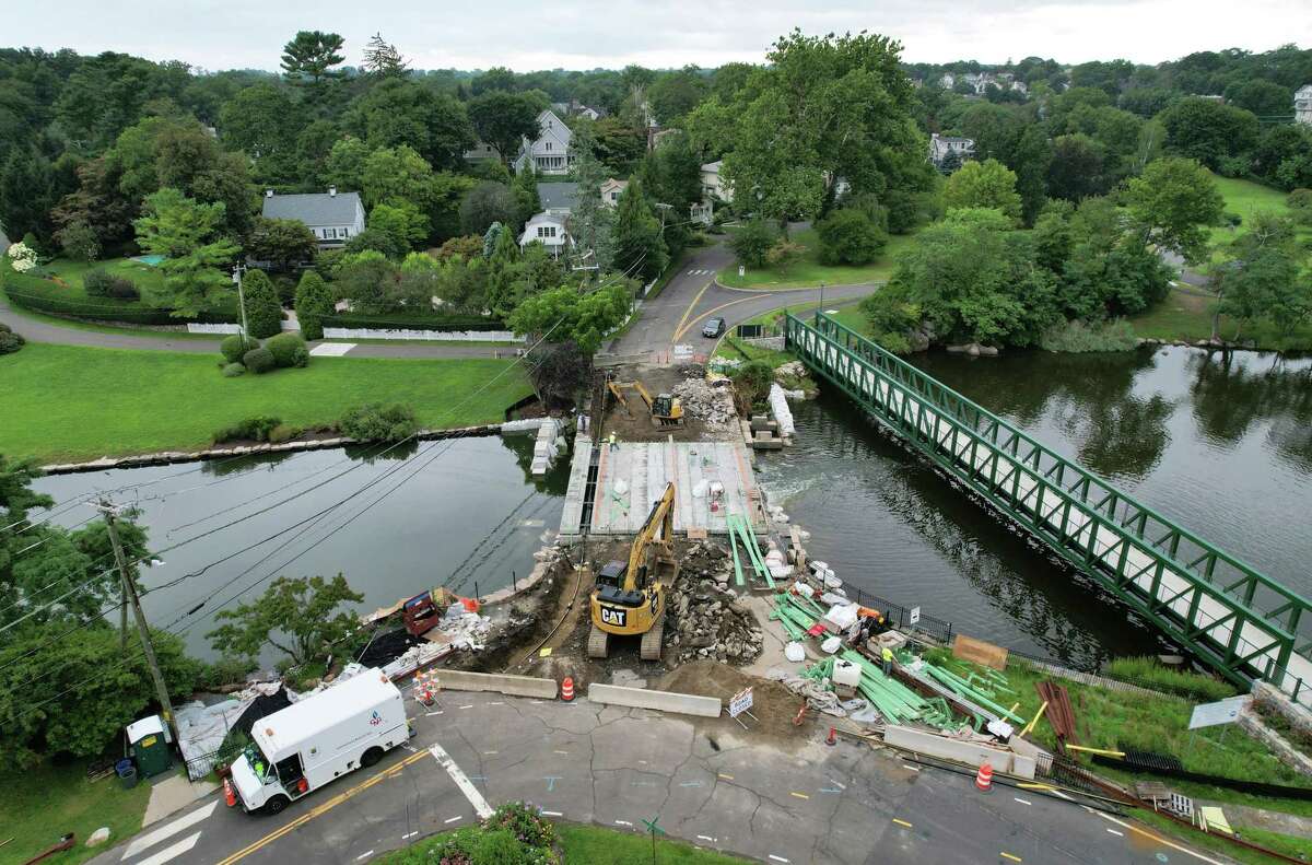 Construction continues on the Davis Avenue bridge in Bruce Park in Greenwich, Conn. Monday, Aug. 9, 2021. The construction is on schedule to have the road reopened by Sept. 1, with the entire project scheduled for completion by spring of 2022. The project crossed a major milestone when the preset deck of the bridge was lifted into place and set on Aug. 2.