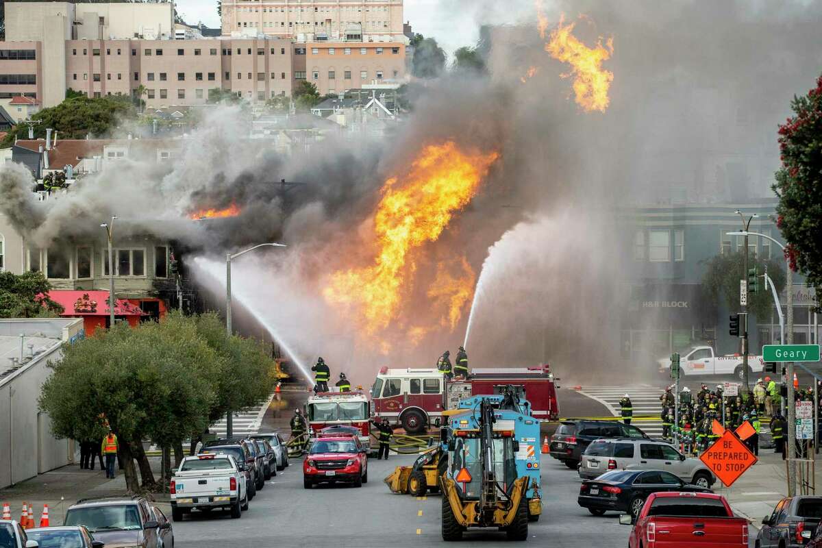 Firefighters battle a fire following an explosion at Geary boulevard and Parker Avenue. The National Transportation Safety Board released the results of its investigation into the incident, finding that while a contractor was mostly to blame, Pacific Gas & Electric Co. did not employ software that could have helped locate shutoff valves faster.