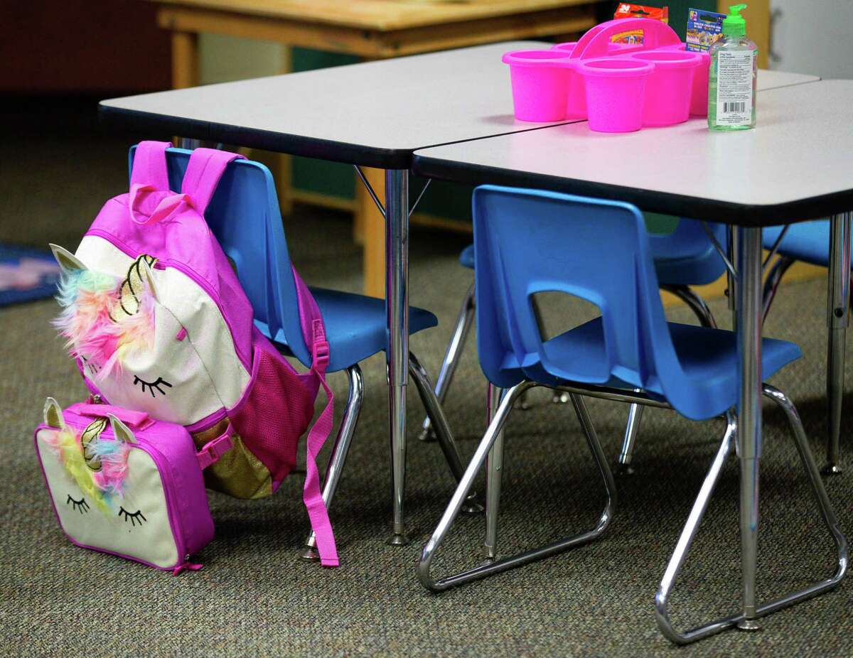 A kindergartener's backpack hangs from a chair during the first day of school at Heflin Elementary on Tuesday, Aug. 10, 2021, in Houston.