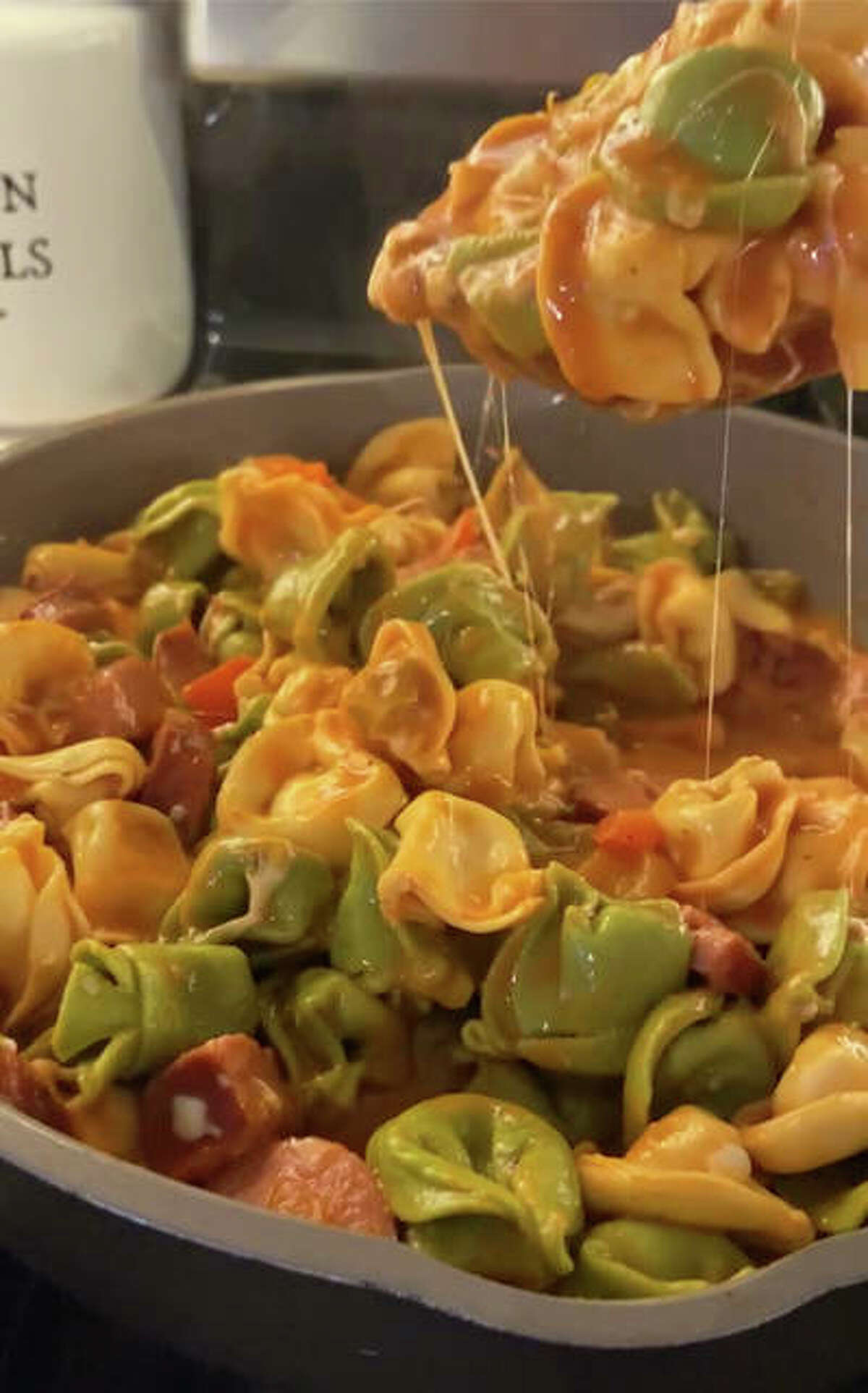 Sausage and tortellini dish is a one-skillet meal packed with cheese and crunchy peppers.