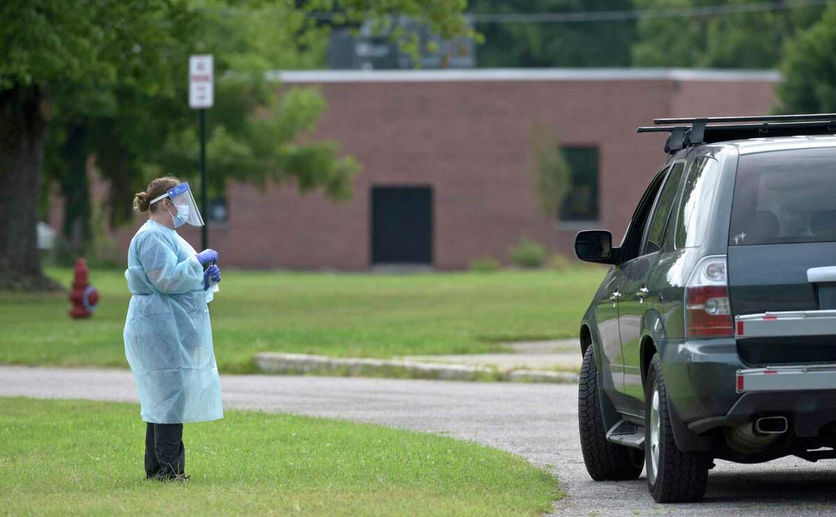 Heidi Bettcher, RN, Public Health Nurse, waits while a client does a self administered COVID test during the first day of the New Milford Health Department's COVID-19 drive-thru testing site at John Pettibone Community Center. Wednesday, August 11, 2021, New Milford, Conn.