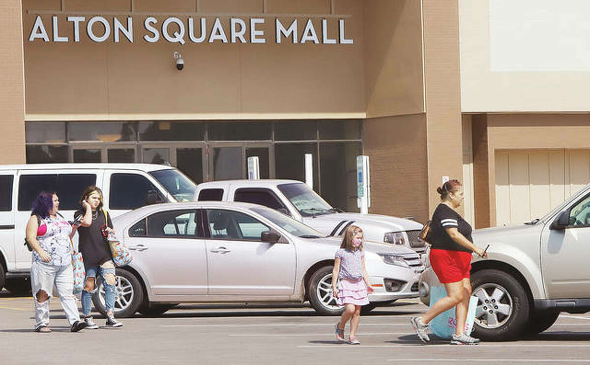 Customers head to their cars Wednesday after shopping at Alton Square Mall. Hull Property Group, which bought the mall in 2015, has been honored by the North Alton Godfrey Business Council for investing millions into improvements at the shopping center. - John Badman|The Telegraph
