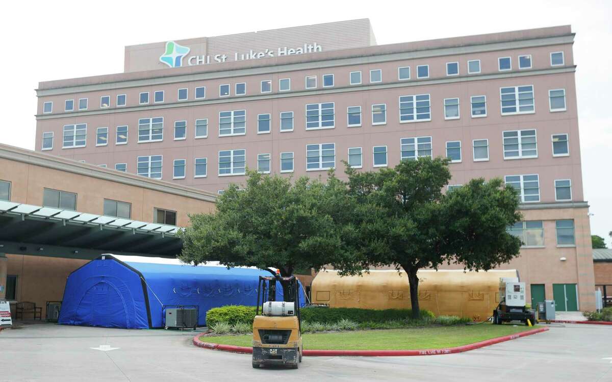 Overflow COVID-19 tents are seen outside CHI St. Luke’s Health - The Woodlands Hospital to help medical staff triage patients as COVID-19 cases surge and hospital reach capacity, Wednesday, Aug. 11, 2021, in The Woodlands. The two large portable tents are expected to lower the time EMS staff is waiting at the emergency room after brining in patients.