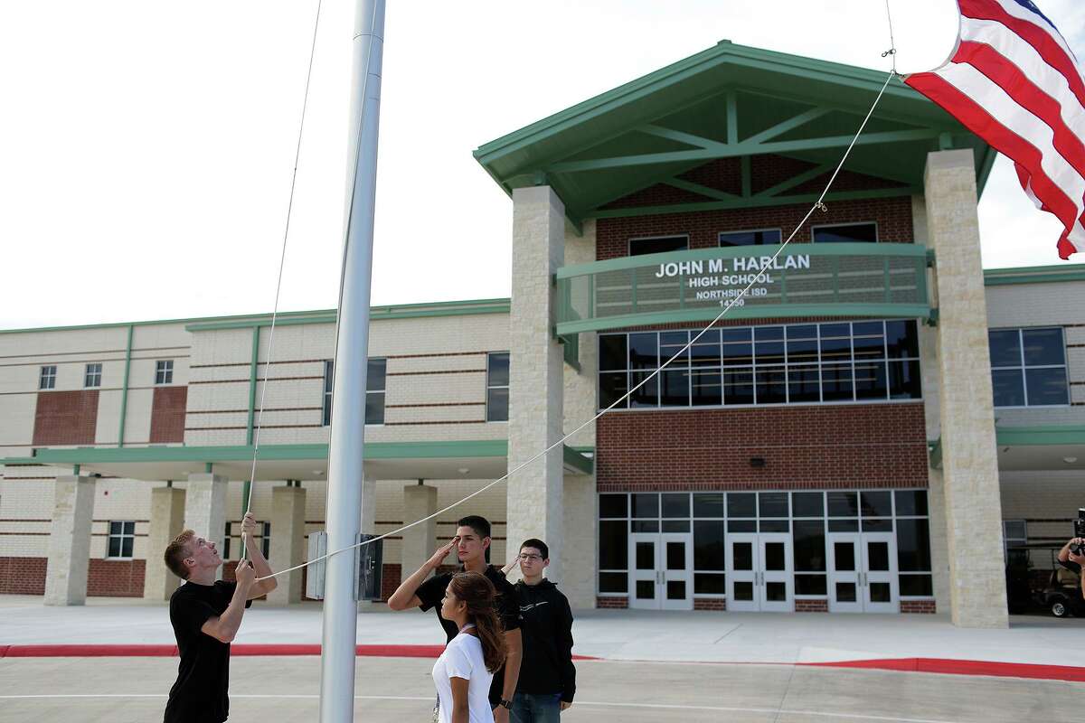 JROTC cadets raise the flag on the first day of classes in 2017 at the then-new Harlan High School in Northside ISD. The school district is playing for time, delaying a decision on a mask requirement as local and state officials fight it out in court.