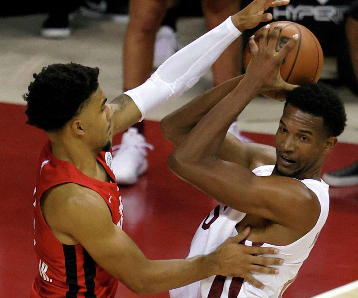 Rockets second-year forward K.J. Martin, left, makes his presence known to highly touted Cavaliers rookie Evan Mobley during a summer league game at the Thomas & Mack Center in Las Vegas.