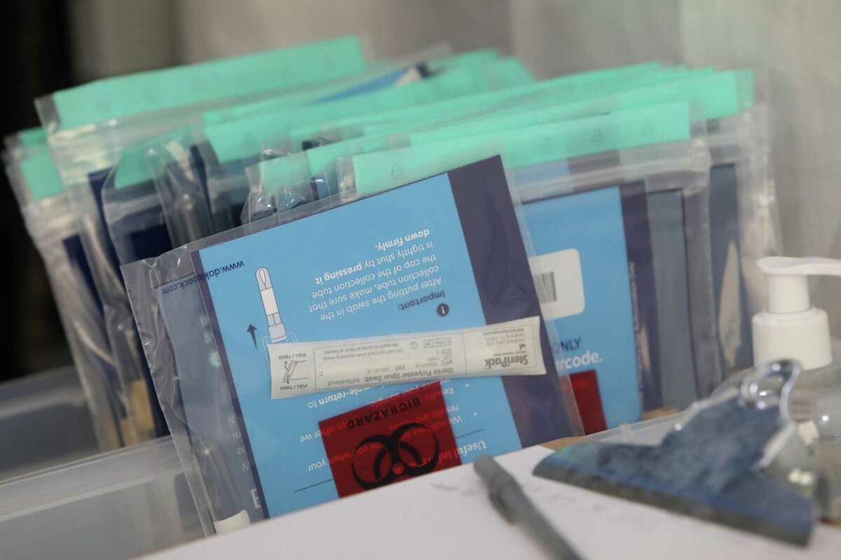Unused COVID-19 test kits are seen in a bin at the self swab employee and student test drop-off site at UCSF Mission Bay on Wednesday, December 2, 2020 in San Francisco, Calif.