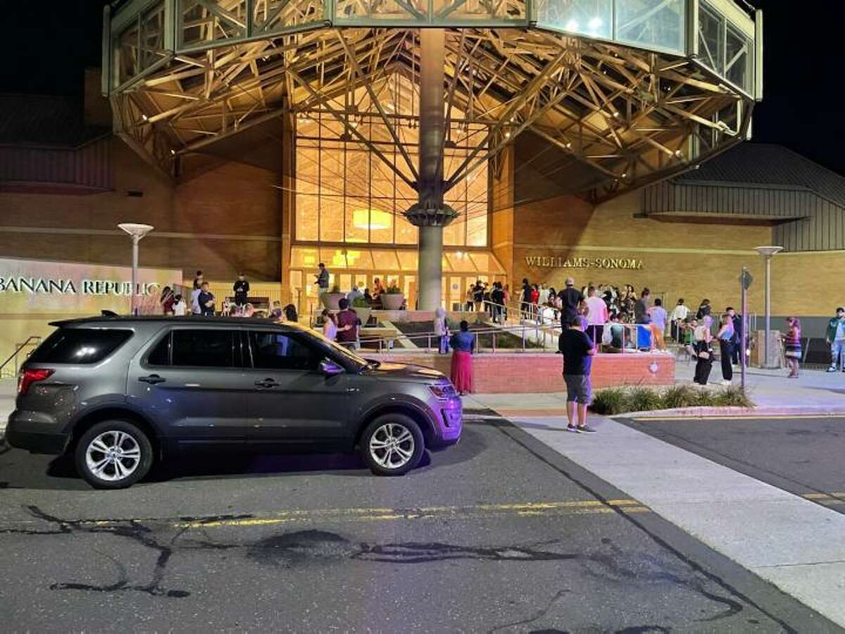 Police maintain a presence outside Danbury Fair mall Wednesday night after a female was shot inside the mall.