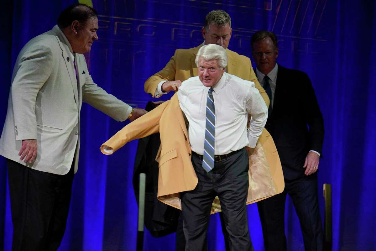 Jimmy Johnson, a member of the Pro Football Hall of Fame Centennial Class, receives his gold jacket during the gold jacket dinner in Canton, Ohio, Friday, Aug. 6, 2021. (AP Photo/Gene J. Puskar)