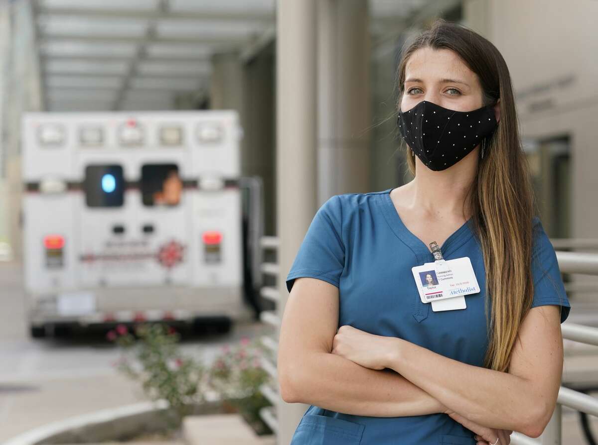 Taylor Cummins, a contract RN recruited from Austin to work in Houston during the summer 2020 surge in COVID-19 cases, is shown outside Houston Methodist in Texas Medical Center, Wednesday, July 8, 2020.