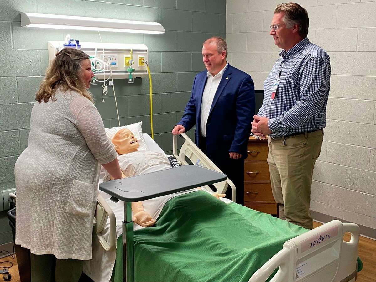 Director of Nursing and Allied Health Shelley Boes , WSCC President Scott Ward, and Spectrum Health Ludington Hospital President Drew Dostal view a high-fidelity manikin while touring the facility. (Submitted photo)