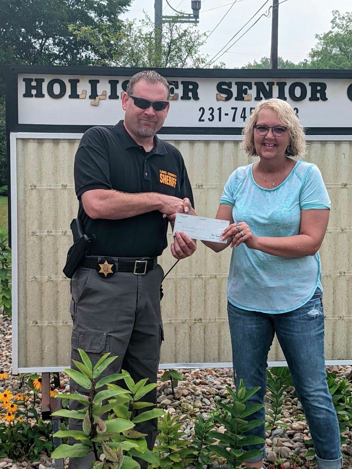 Lake County Sheriff Rich Martin presented Cheri Davidson, with the Hollister Center, with a check for $2000 from the Sheriff's department charitable campaign. (Submitted photo)