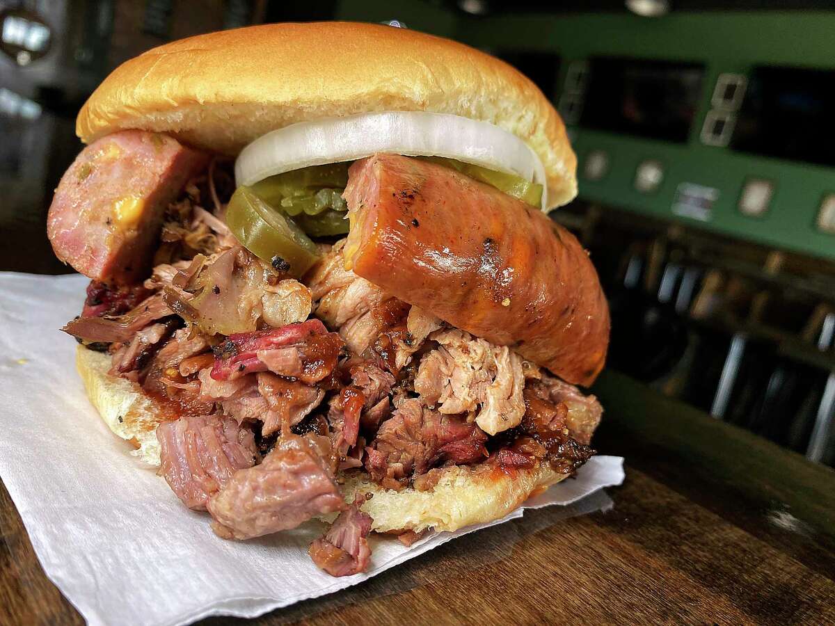 The Double Dare You sandwich comes with brisket, pulled pork and jalapeno-cheese sausage at Whiskey Tango Foxtrot BBQ, a food trailer parked beside the Stout House bar on Potranco Road.