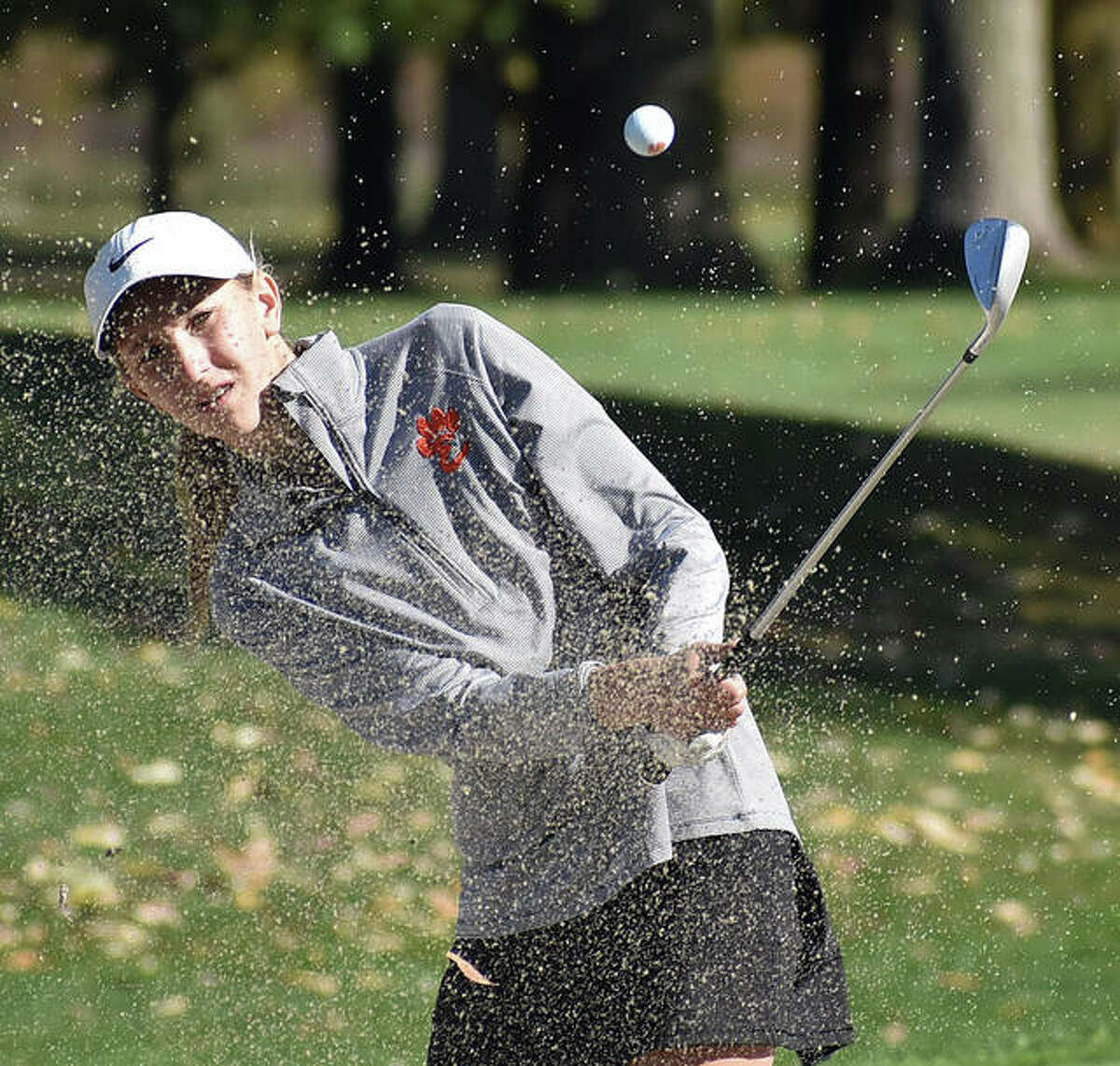 Edwardsville’s Grace Daech watches her shot fly out of the bunker during a tournament last season for the Tigers.