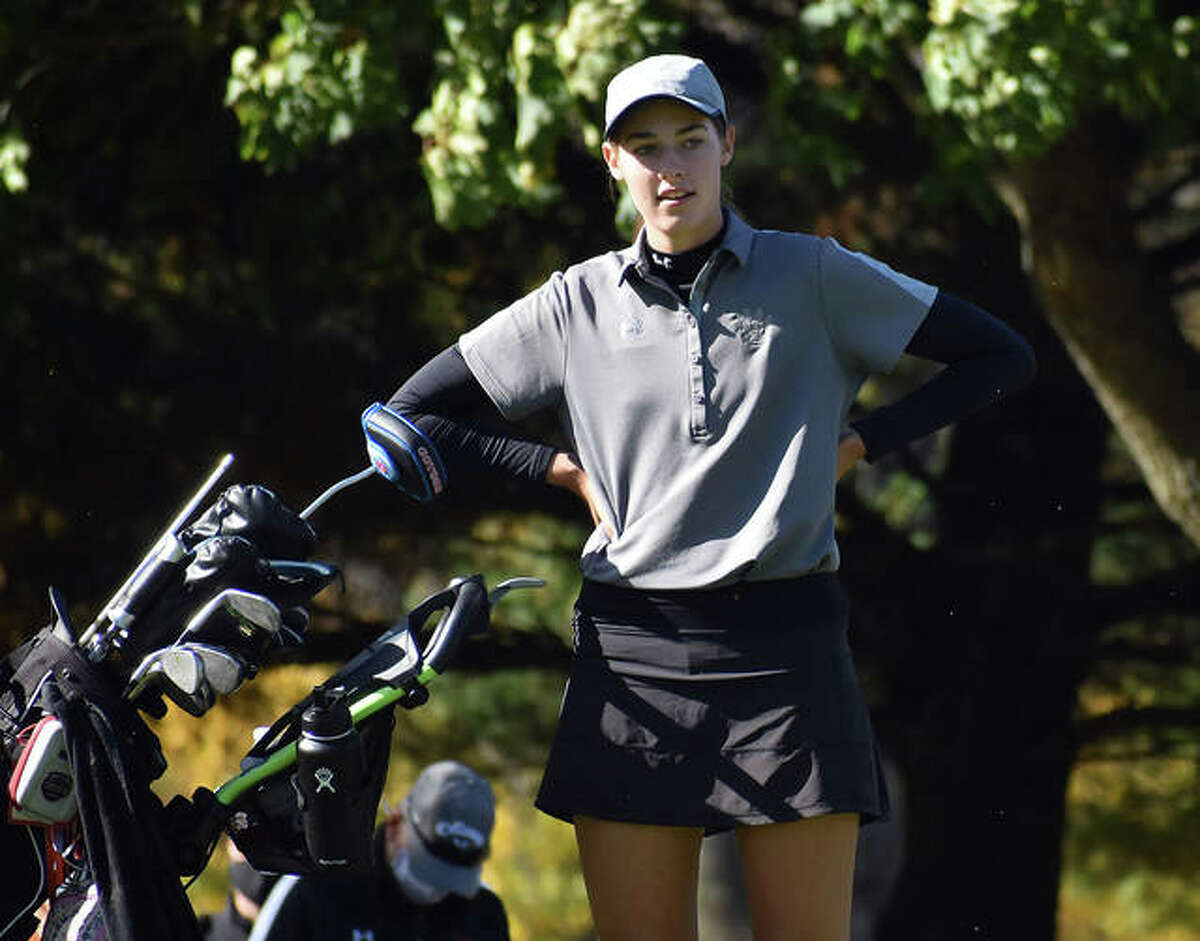 Edwardsville’s Nicole Johnson waits patiently on the green after ending her round and winning the Class 2A Champaign Centennial Sectional title.