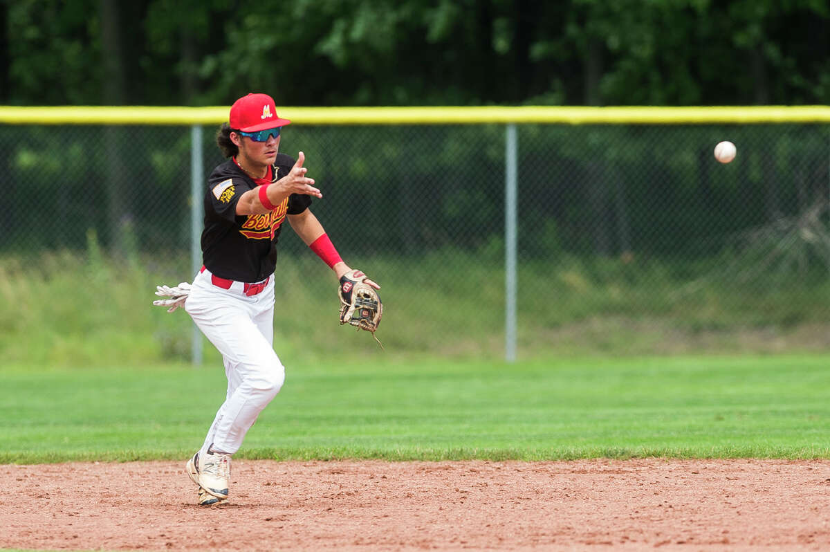Berryhill’s Griffin Clark flips the ball to second-baseman Logan McCoy (not pictured) during a July 23, 2021 American Legion Zone 4 tournament game against Petoskey.