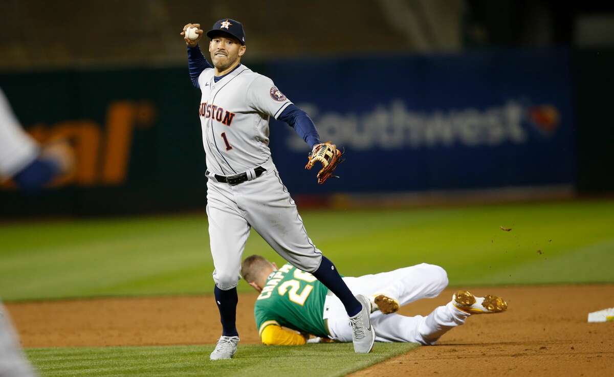 Carlos Correa of the Houston Astros turns two after colliding with Oakland's Matt Chapman during the game against the Athletics at RingCentral Coliseum on April 2, 2021 in Oakland, California.