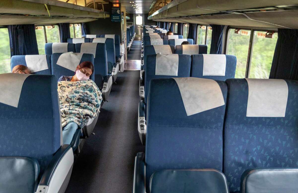 A passenger on Amtrak’s Texas Eagle, which runs from San Antonio to Chicago, sleeps Monday, Aug. 9, 2021 as the train runs between San Antonio and Austin. If President Biden’s infrastructure deal passes the train’s current once-per-day schedule could potentially be expanded to three times per day on the San Antonio to Fort Worth section of the route.