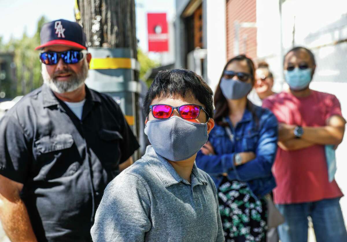 Benjamin Kai Lee (center) of Antioch uses EnChroma’s sunglasses, which aid those with colorblindness.