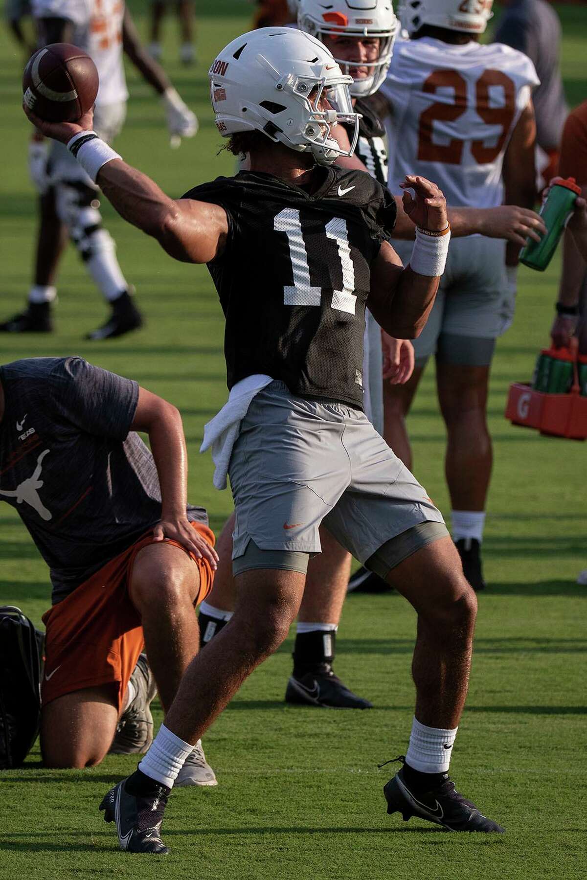 Texas quarterback Casey Thompson passes to a teammate during drills at an NCAA college football practice in Austin, Texas, Friday, Aug. 6, 2021. (Mikala Compton/Austin American-Statesman via AP)