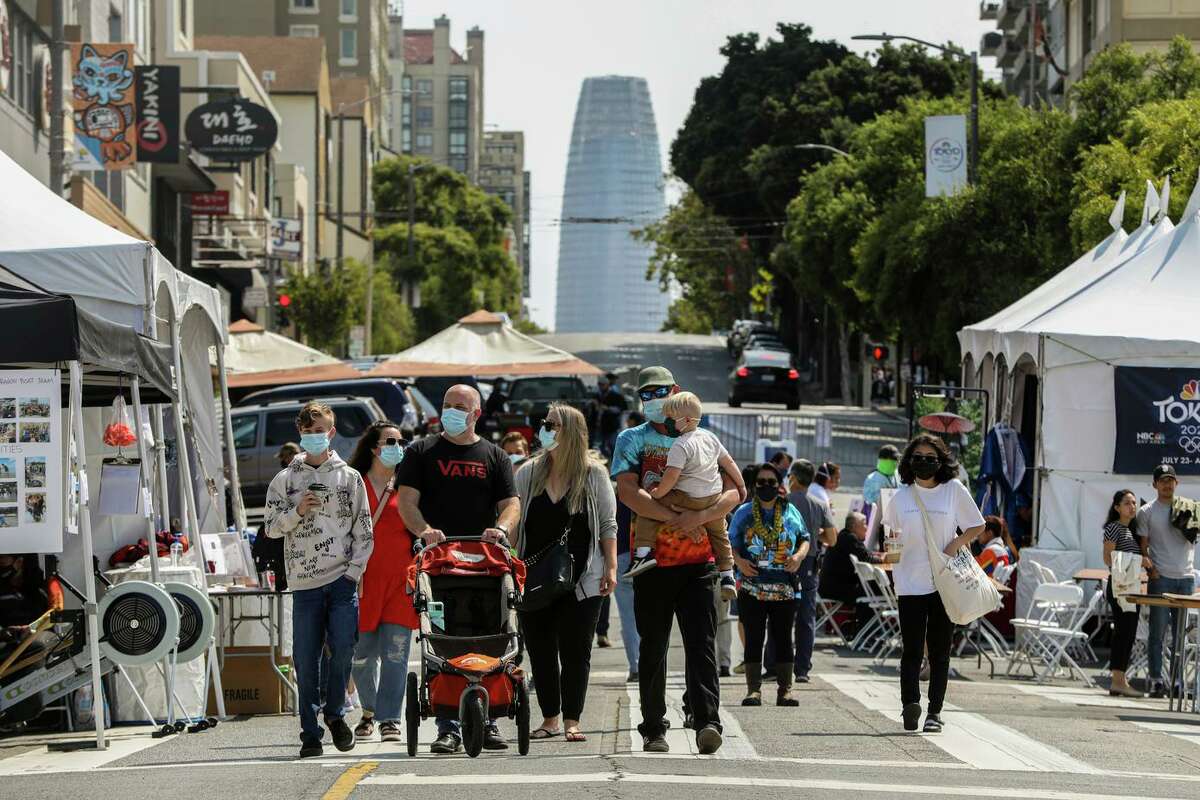 Attendees move through the annual Nihonmachi Street Fair in S.F. on Sunday. Experts say that the density of the city’s population could be a factor in the increasing COVID case rate.