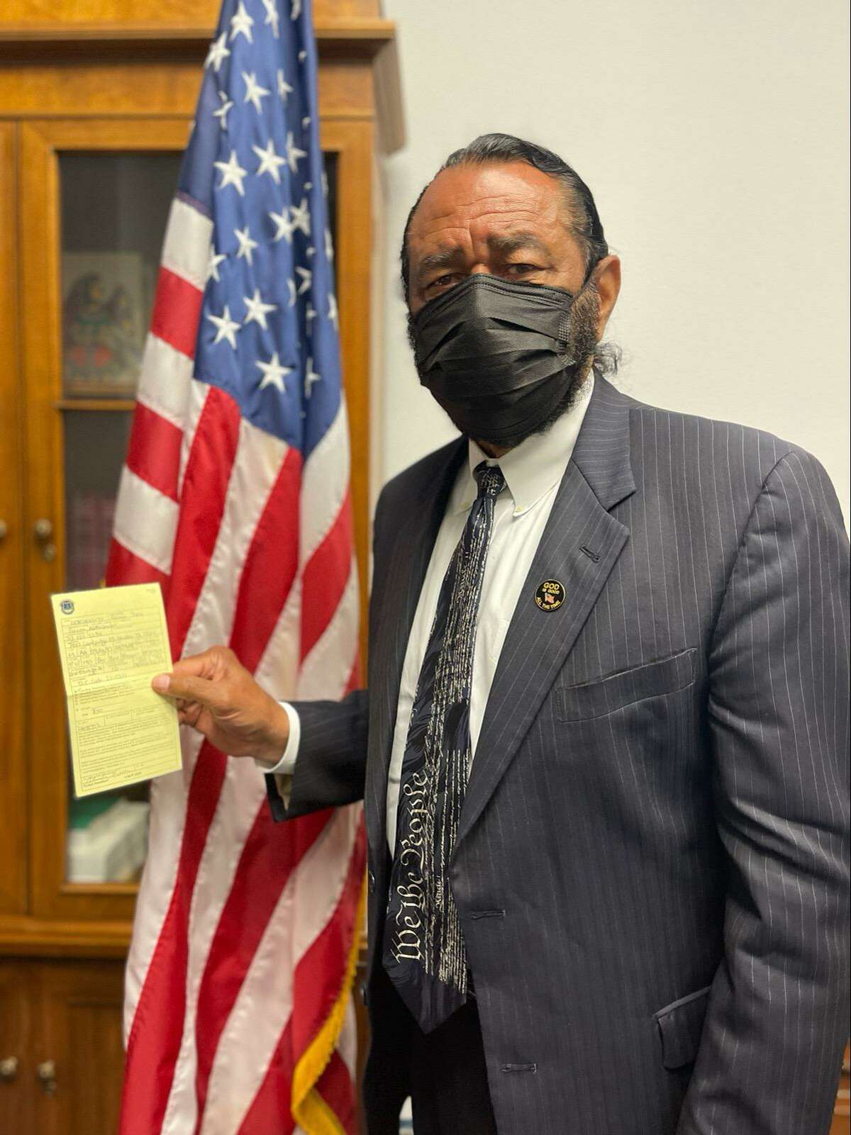 U.S. Rep. Al Green, D-Texas, holds up the citation he received after being arrested for civil disobedience while protesting voter suppression.