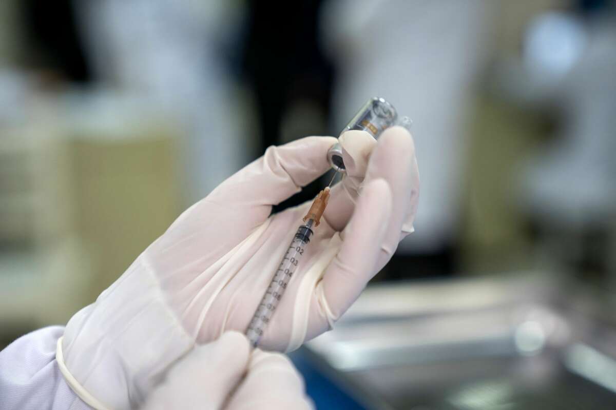 ENSHI, CHINA - DECEMBER 30: A medical worker prepares the COVID-19 vaccine at a clinic on December 30, 2020 in Enshi, Hubei Province of China. (Photo by Xie Chuanhui/VCG via Getty Images)