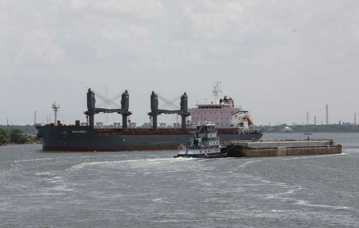 A barge navigates past a large ship Monday, Aug. 2, 2021, in the Houston Ship Channel near Channelview.