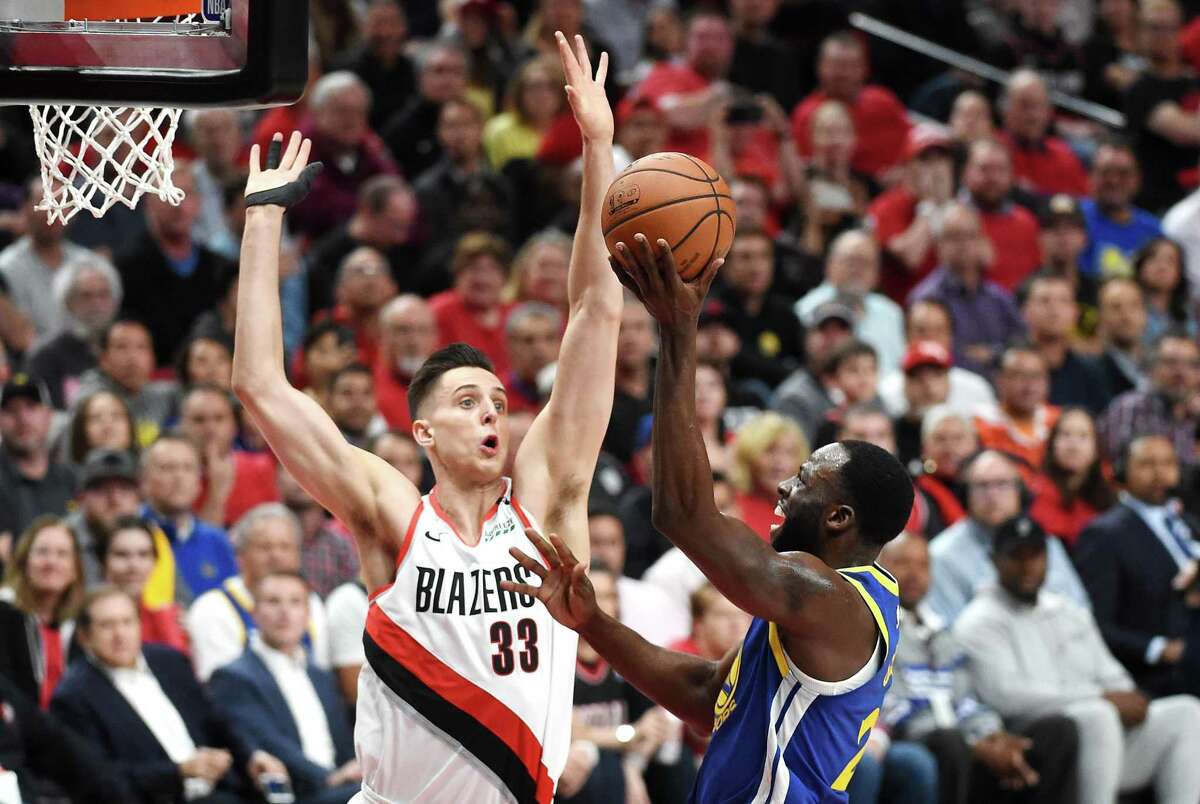 Draymond Green #23 of the Golden State Warriors shoots the ball against Zach Collins #33 of the Portland Trail Blazers during the first half in game four of the NBA Western Conference Finals at Moda Center on May 20, 2019 in Portland, Oregon. 