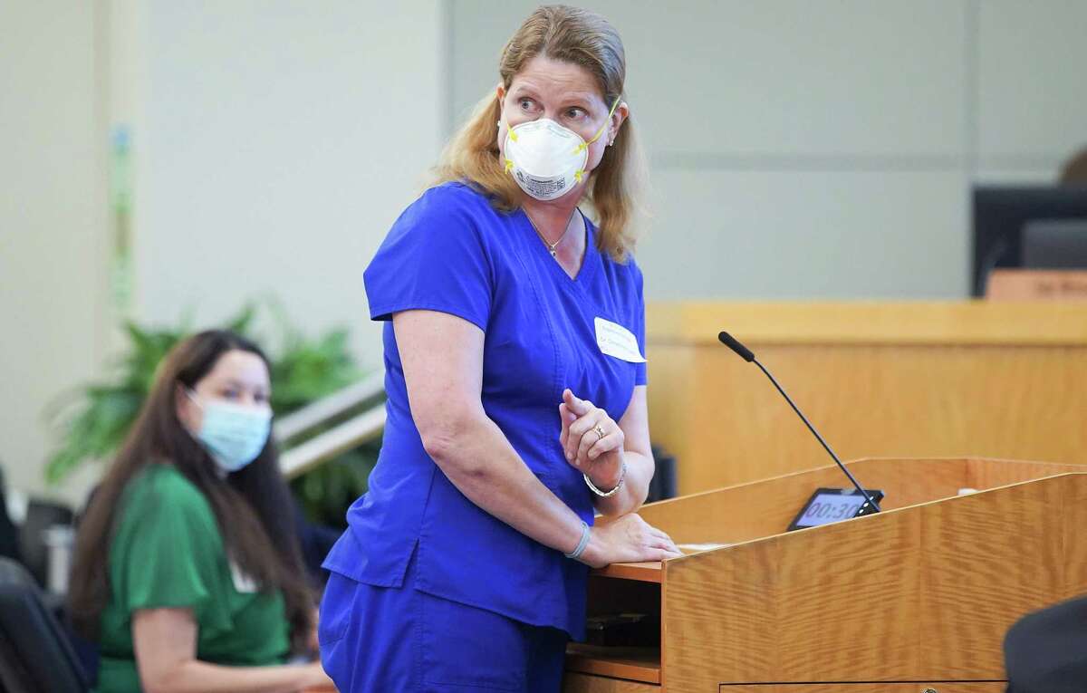 Pediatrician Christina Propst pushes back as the crowd interrupts her while she talks in favor of a mask mandate Thursday at the HISD board’s meeing.