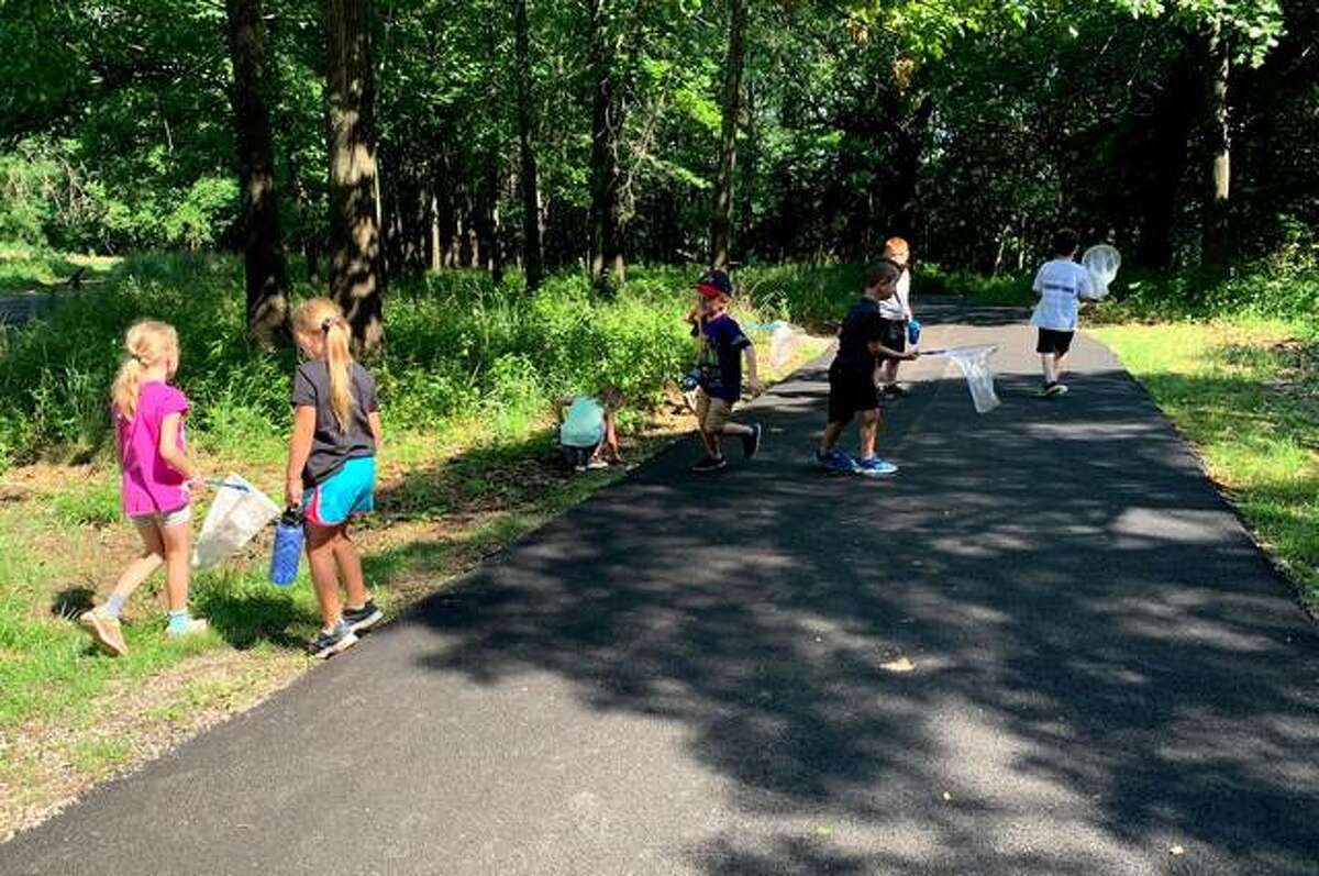 Children walking on new Frog Trail, a paved walking trail open for people of all abilities.