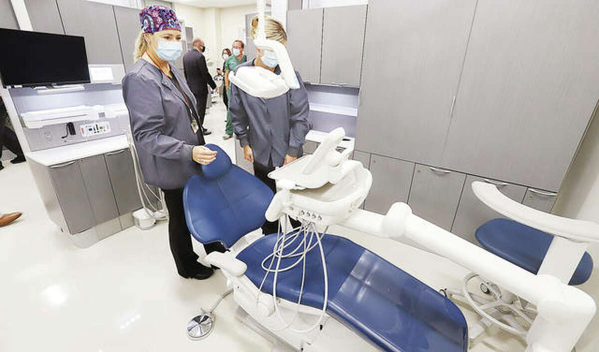 Melissa Probst, left, Dental Hygiene Supervisor at the SIU School of Dental Medicine in Alton and Crystal Wesley, right, Dental Unit Coordinator, look over work stations in the dental school’s new Advanced Care Clinic which was opened Monday morning.
