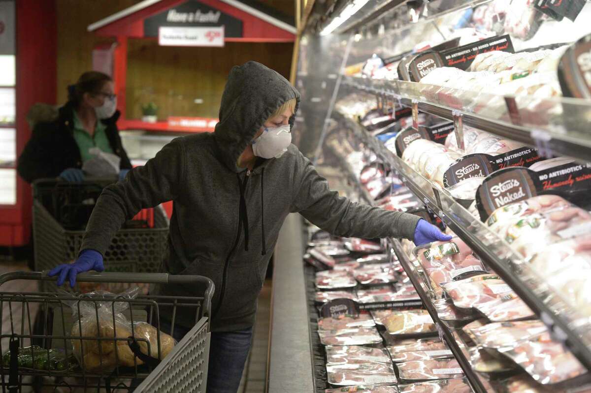 Jane Blackwell, of Brewster, N.Y., wears a mask while shopping at Stew Leonard’s in Danbury, Conn., in April 2020.