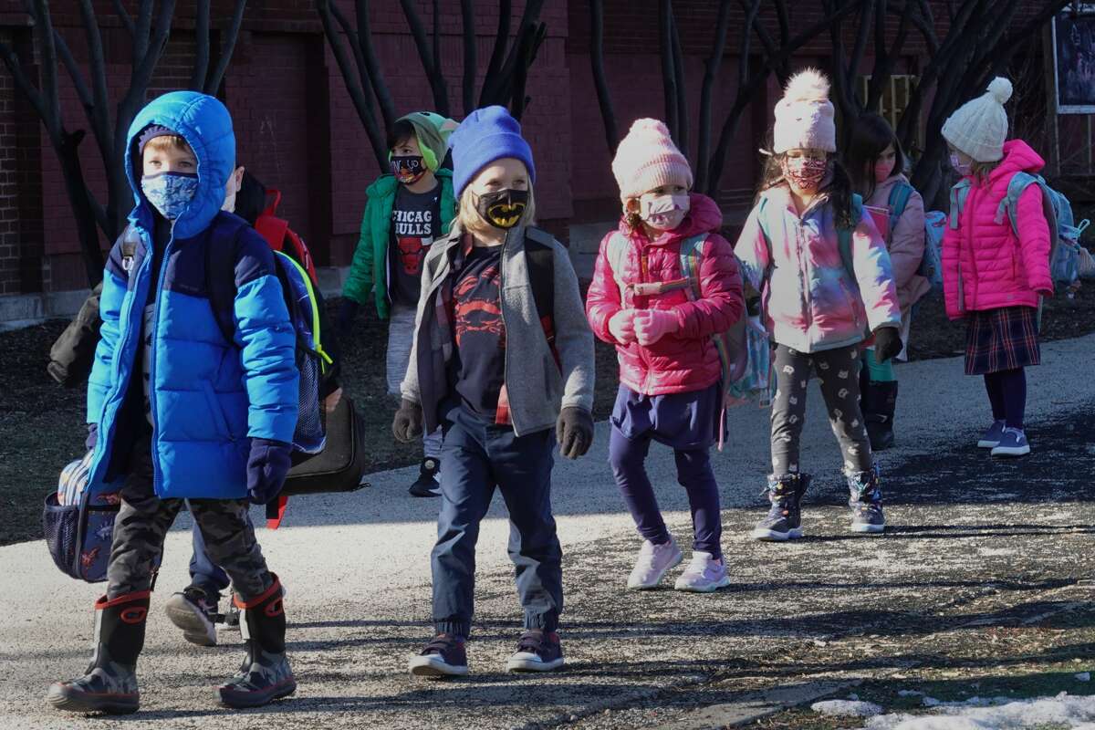 Students are escorted from Hawthorne Scholastic Academy to meet their parents following their first day of in-person learning on March 01, 2021 in Chicago, Illinois. (Photo by Scott Olson/Getty Images)