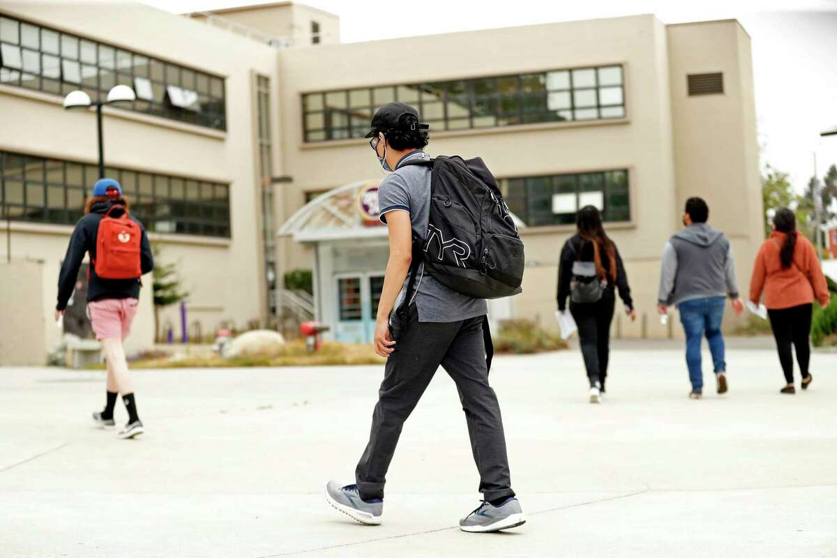 On Thursday, a week before the academic semester begins, young people walk on campus at San Francisco State University. San Francisco State University is among the California campuses that have hired vendors to scrutinize vaccination cards for signs of anything amiss, amid worries about fakery.
